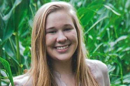 smiling young woman in a corn field