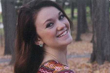 smiling young woman looking over her shoulder
