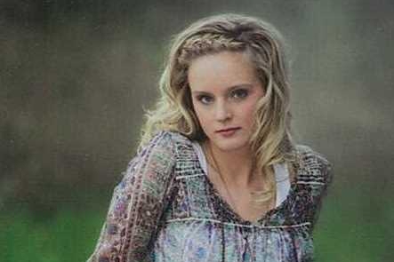 young woman with front braided blonde hair