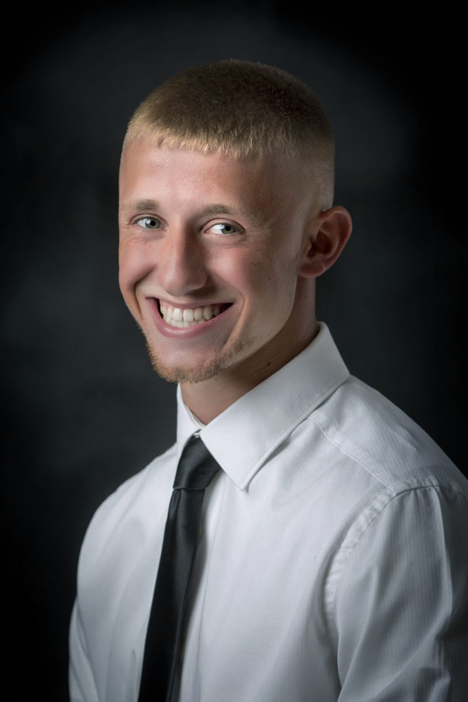 smiling young man in dress shirt and tie