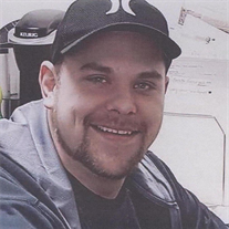 smiling man with facial hair and dimples wearing a baseball cap