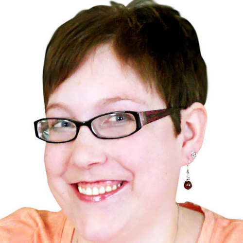 smiling woman with thin rimmed glasses and short brown hair