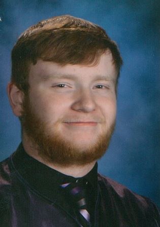 studio portrait of young man with red hair and beard