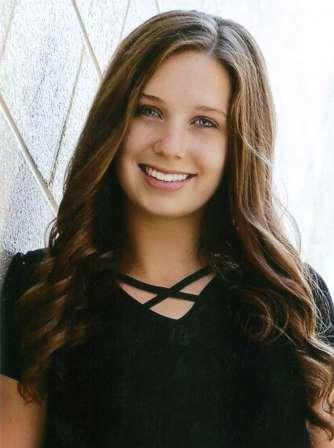 smiling young woman with wavy brown hair