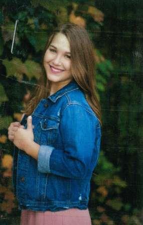 smiling young woman in jean jacket