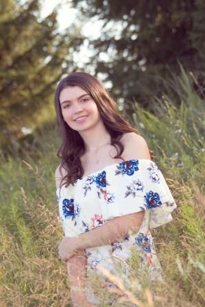 smiling young woman posing in a field